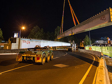 A night time photo of a crane lifting pieces of the Sydney Monorail.