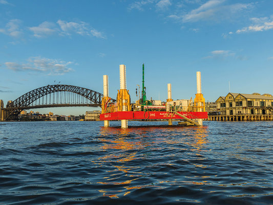 Early works drill barge on the harbour with Sydney Harbour bridge in view.