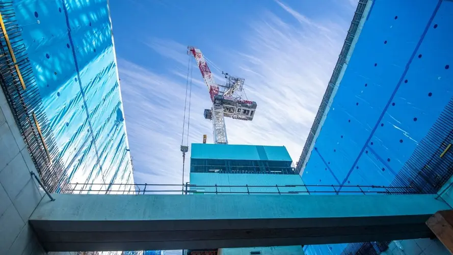 Crane lifting a precast concrete section into the Waterloo Station box