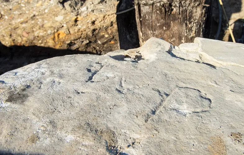 A close up look at a 'WP' rock engraving found at Barangaroo Station.