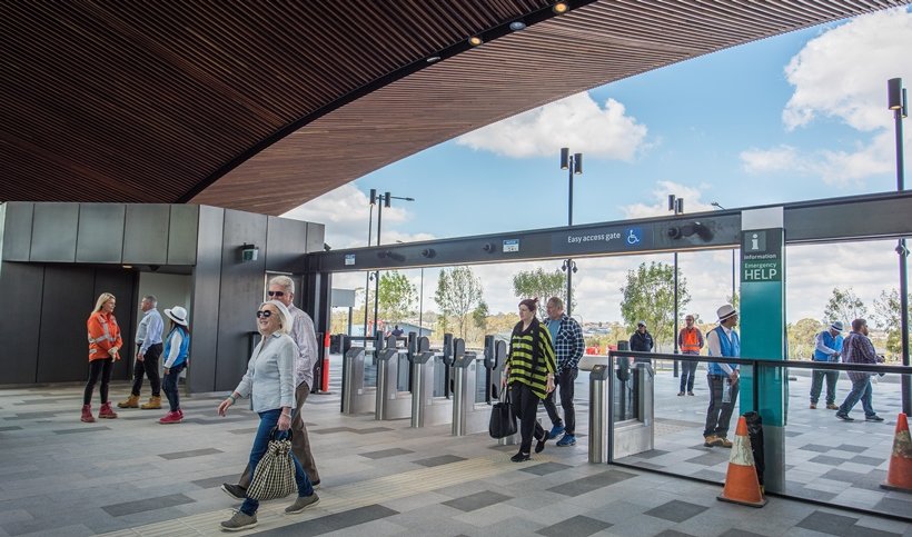 A group of community members commuting inside the station entrance of Sydney Metro's Tallawong Station as part of the community day event.