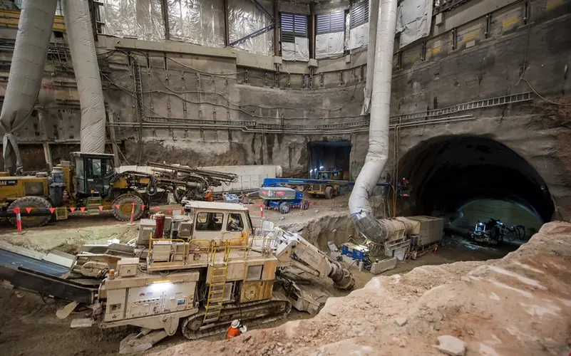 An above the ground view looking down at the construction site with five excavators working on the tunnels at Sydney Metro's Victoria Cross site.