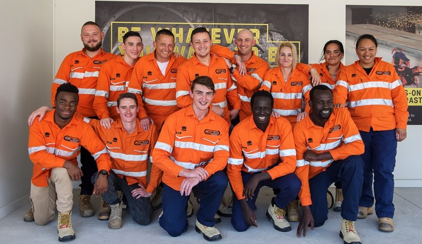 A group of 13 graduates from TAFE pictured wearing PPE. 