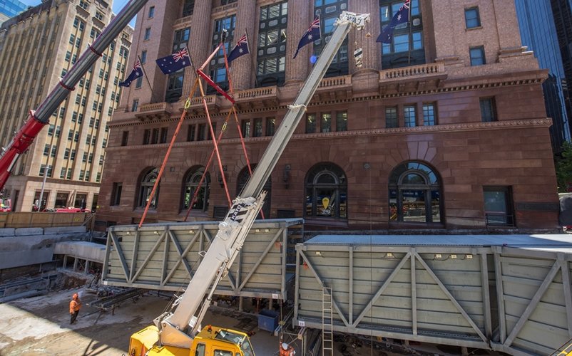 Pedestrian walkway being craned into place at the construction site of Sydney Metro's Martin Place Station. 