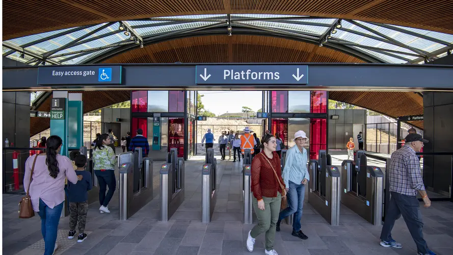 Cherrybrook Metro station pictured from the entrance with patrons walking in and out of opal gates