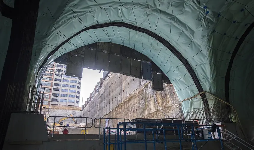 A view from inside Pitt Street North construction site looking out towards the Sydney city skyline.