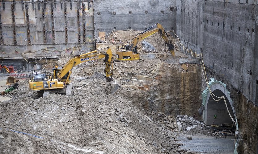 Two digging machines excavating a large mound of spoil at Pitt Street North construction site