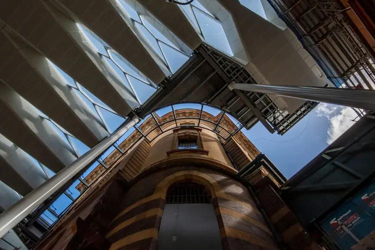 A view from below of the new canopy roof enhancing the heritage aesthetics of Central Station. The blue sky can be seen through the glass panels.