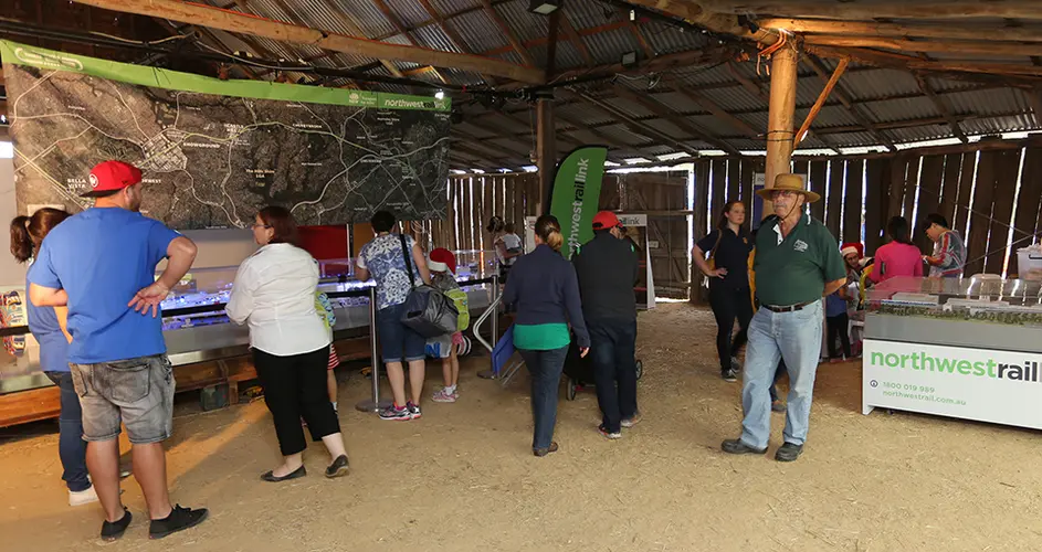 A number of people are gathered at an event to learn more about Northwest Rail.