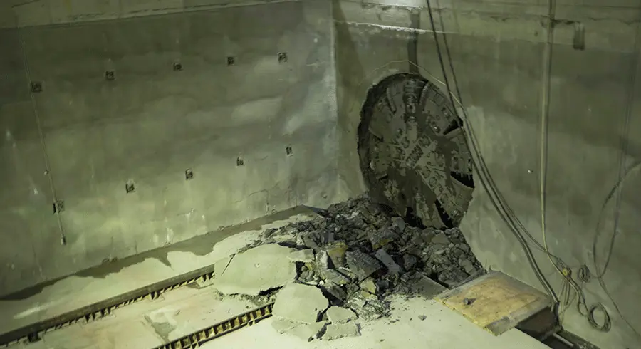 The cutterhead on tunnel boring machine Elizabeth can be seen breaking through the wall in the station box cavity