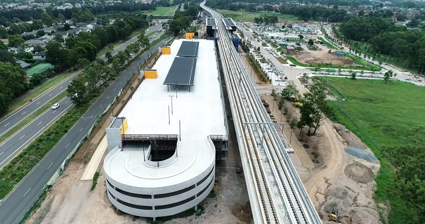 A bird's eye view looking down at the multi-story carpark build next to the train tracks leading to Sydney Metro's Kellyville Station.