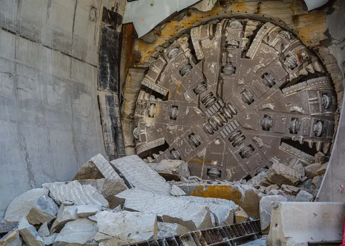 An on the ground view showing Tunnel Boring Machine (TBM) 3 Isabelle breaking through the stone at Sydney Metro's Epping Station.