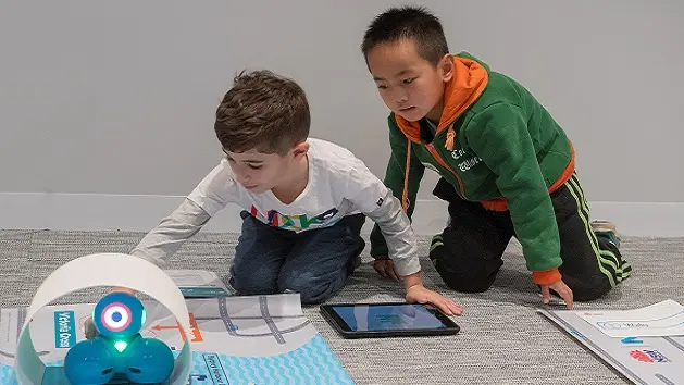 Two students participating in the fun with robots workshop as part of Sydney Metro's Education Program.