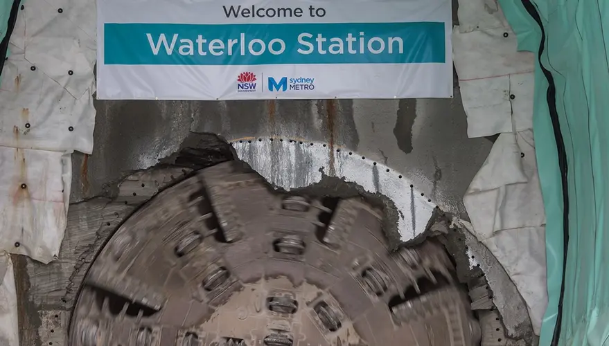 Tunnel Boring Machine (TBM) Nancy breakthrough with a banner displaying Sydney Metro's Waterloo Station.