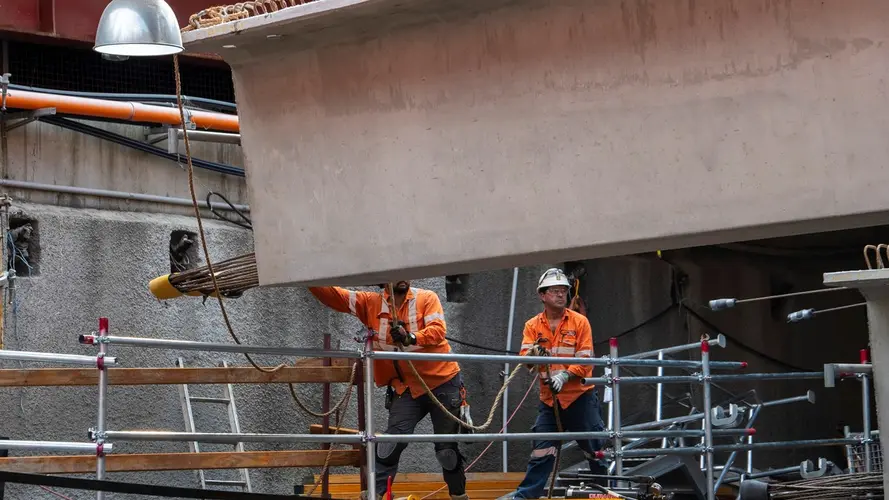 Workers installing precast beams in the Barangaroo Station box
