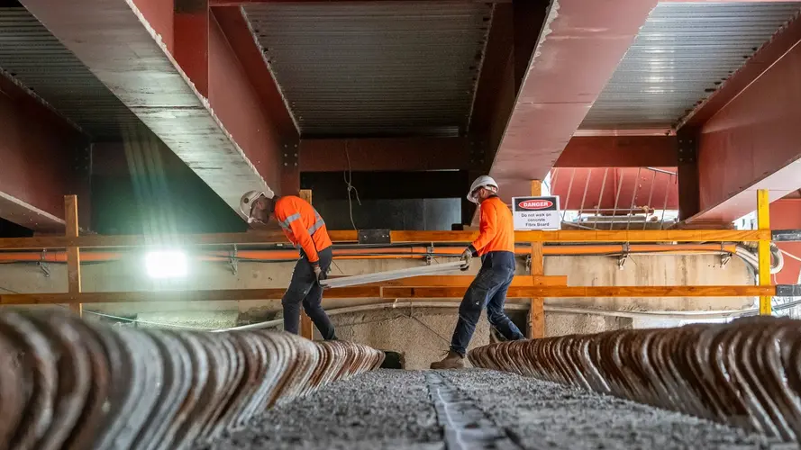 Workers installing precast beams in the Barangaroo Station box