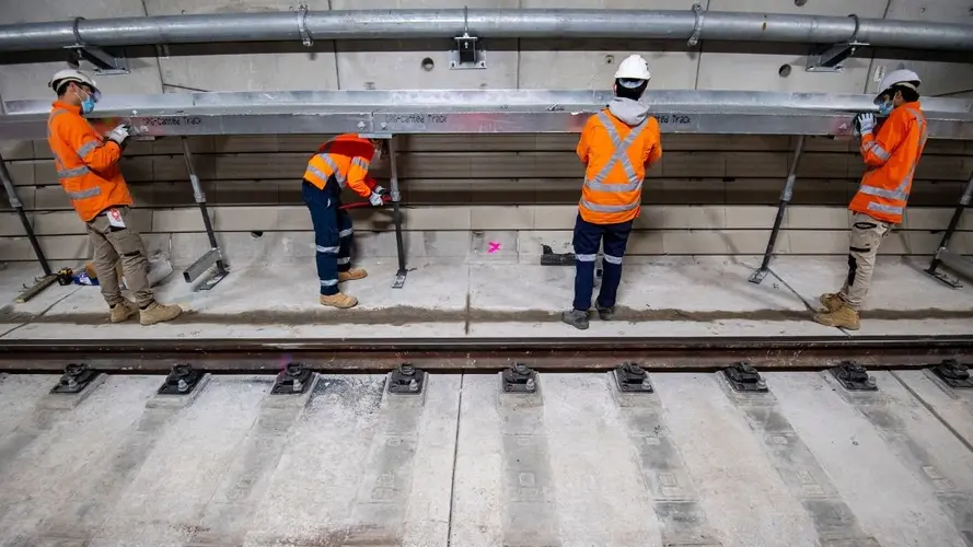 A safety walkway is installed inside the Sydney Metro tunnels just north of the Blues Point access shaft.