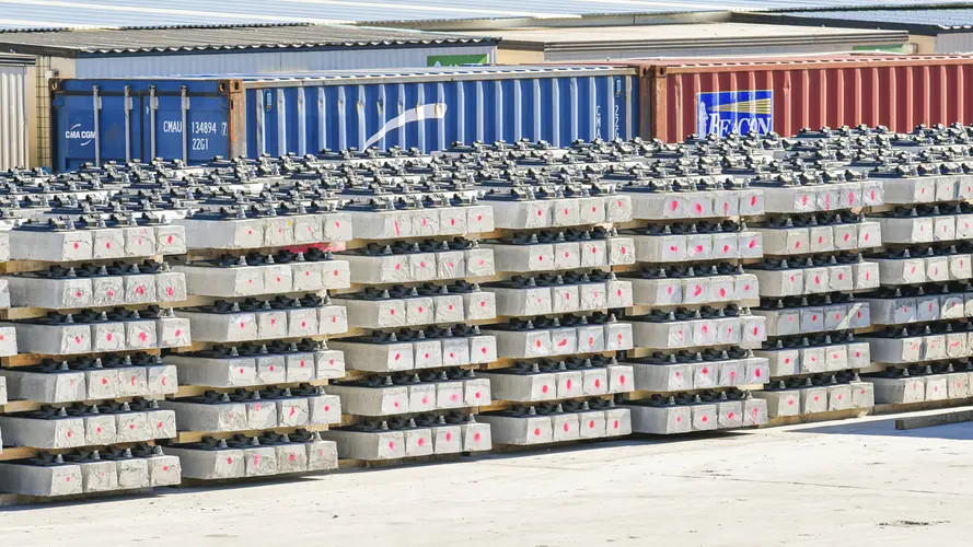 Stacks of pre-cast concreate are lined up in front of several shipping containers at Sydney Metro Trains Facility South Yard.