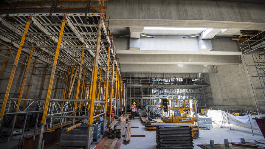 A view of the construction happening beneath the concourse level as the ceiling of the future station platform takes shape.