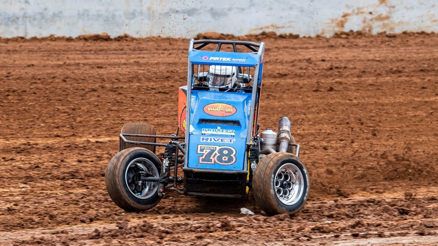 A blue race car spins out in the dirt track at the new Eastern Creek Speedway.