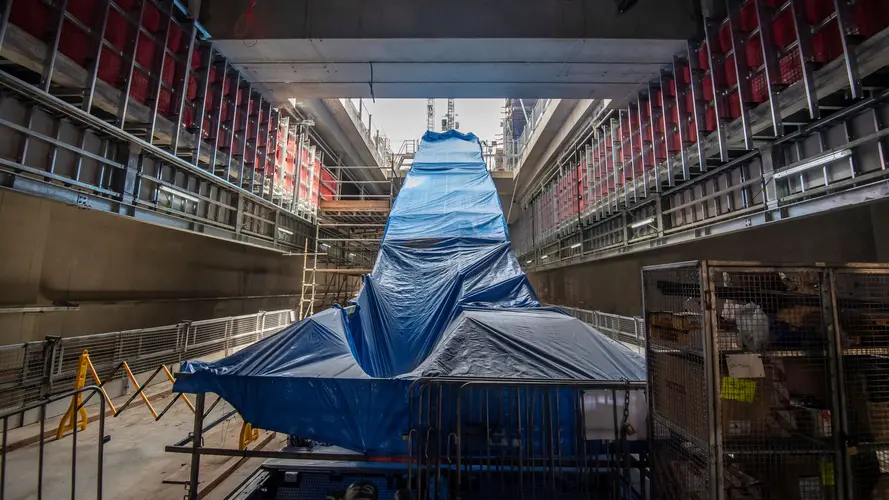 New escalators covered in blue tarp are ready for installation on B3 level (concourse) down to the platform level at Waterloo station