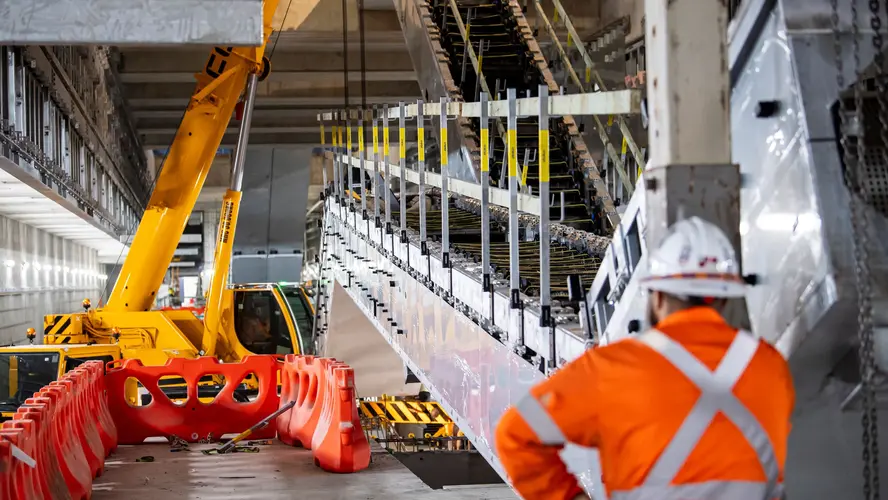 Construction worker installing escalators at Barangaroo Station.