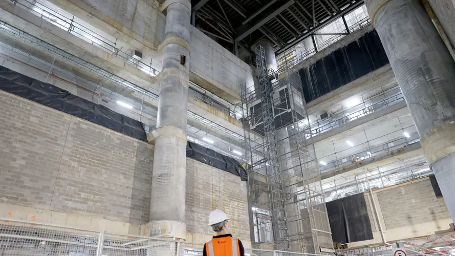 A ground up view of construction worker viewing the construction of the atrium at Sydney Metro's Martin Place Station.