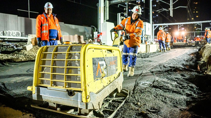 Construction worker using a concrete levelling machine at Sydney Metro's Chatswood Station