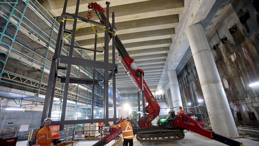 Crane lifting steel structures into the Barangaroo Station box