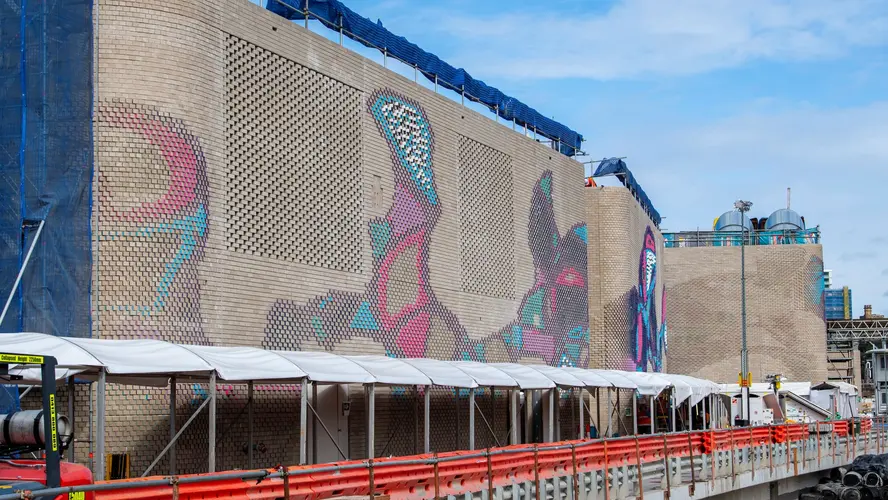 Colourful aboriginal artwork covers the brick ventilation buildings at Central Station.