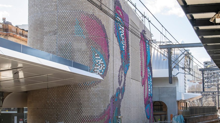 Colourful aboriginal artwork covers the brick ventilation buildings at Central Station.