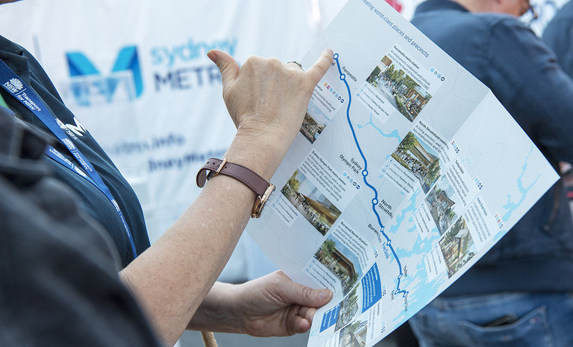 Sydney Metro team member pointing at map of alignment