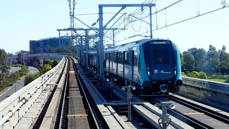 Wide shot of metro train travelling along metro line.