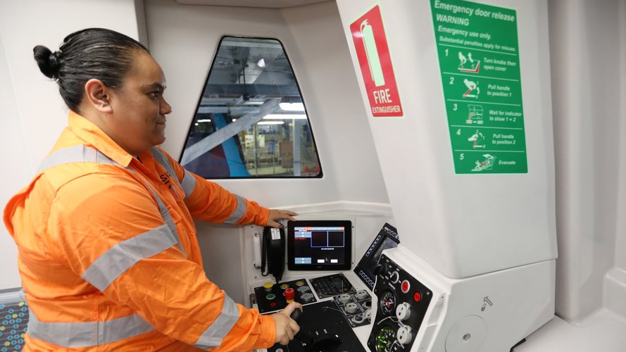 A person in orange high-vis is driving the metro train during testing under Sydney Harbour.