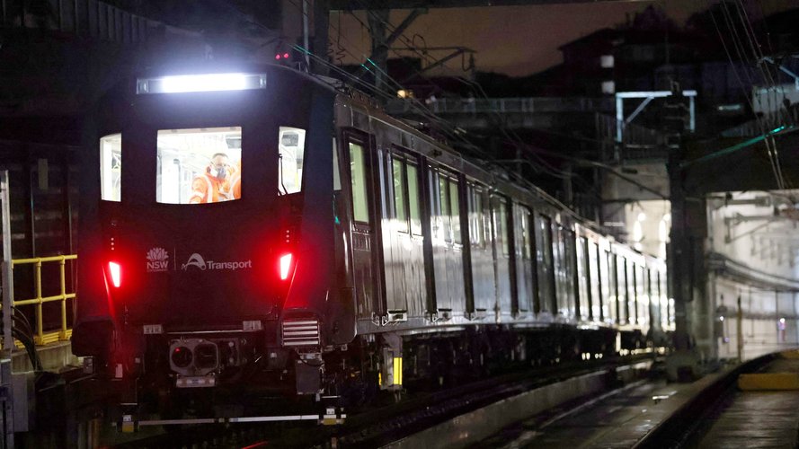 A metro train drives at night during train testing for the City & Southwest project.