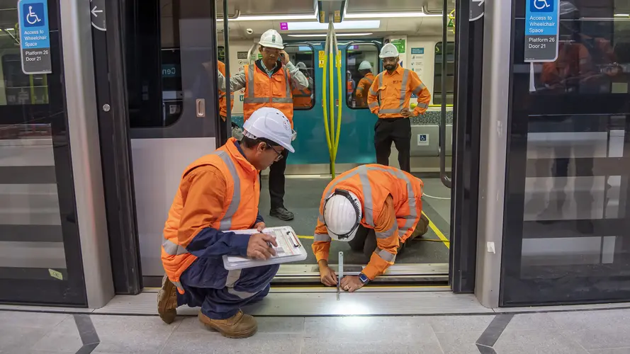 Train door and platform door is being measured and tested by engineers