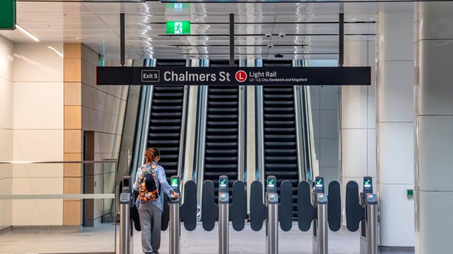 A young woman is using the new Chalmers st entrance at the Central Station by tapping on her opal card at the opal gate