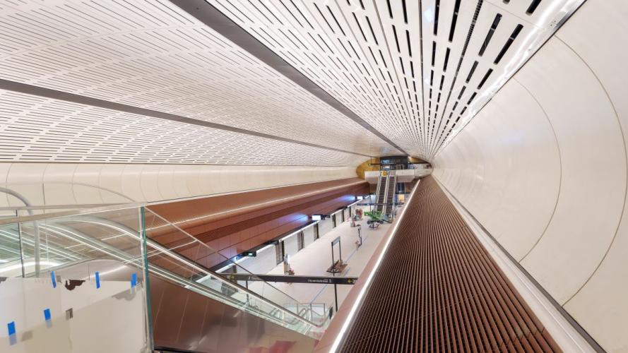 Inside of newly built Victoria Cross Station with escalators and platform