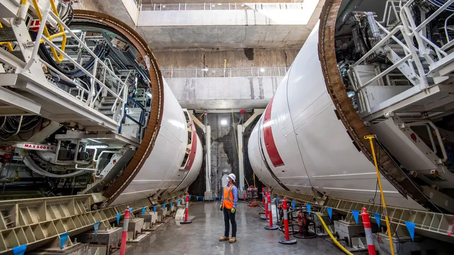 A worker looking upon a set of TBM machines