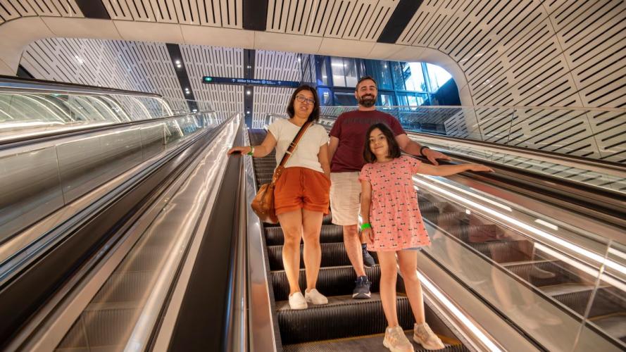 Family of three going down the escalator