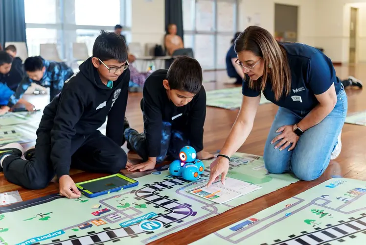 one Sydney metro staff with two school boys at an education event