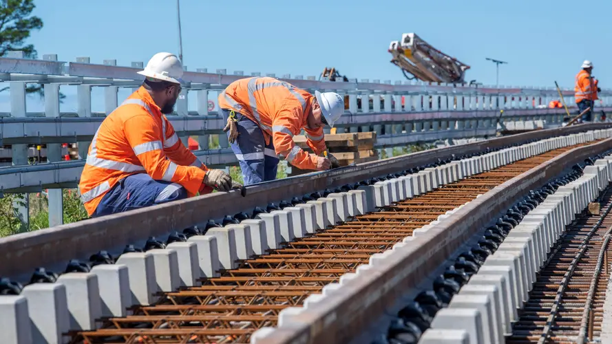 construction workers are laying the track