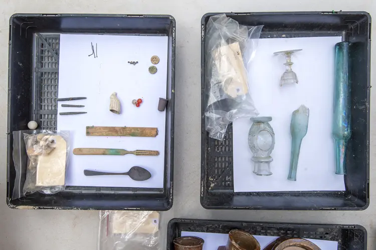 Glass and miscellaneous items, including a toothbrush, a spoon, a thimble and buttons, retrieved from a drain sump where they were originally deposited in the 1830s..jpg