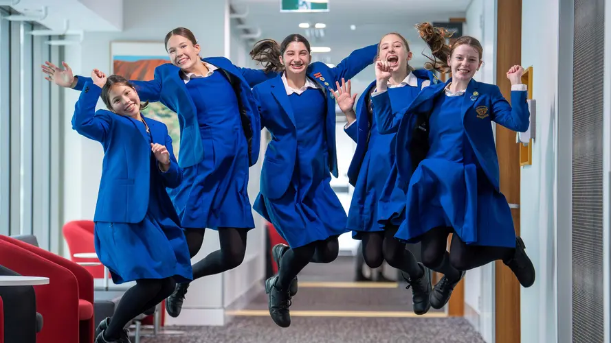 Metro Minds winners celebrating their win with jump
