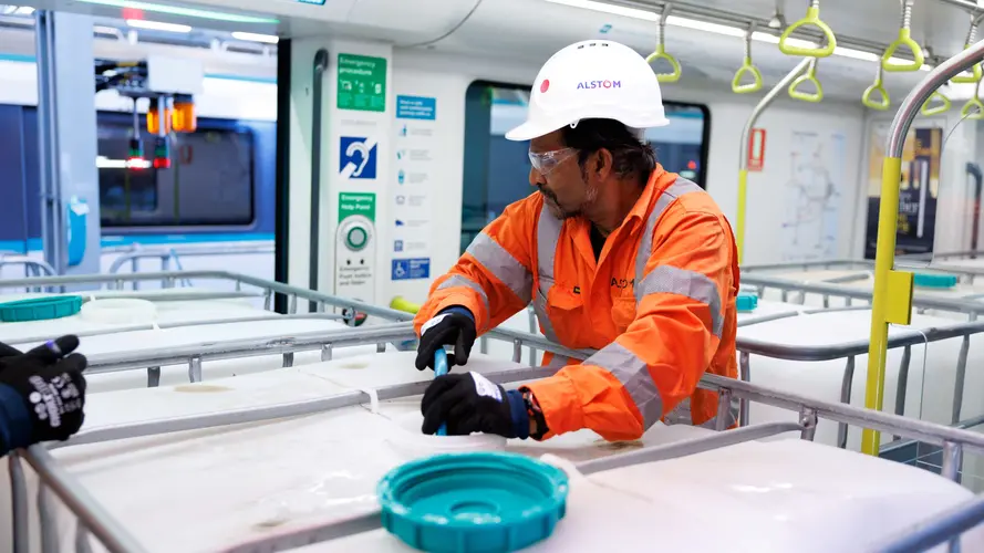 Construction worker loading a water cannister