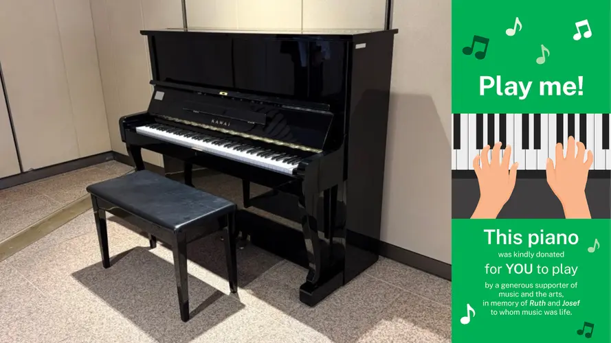 Piano at Martin Place station showing the 'Play me!' banner